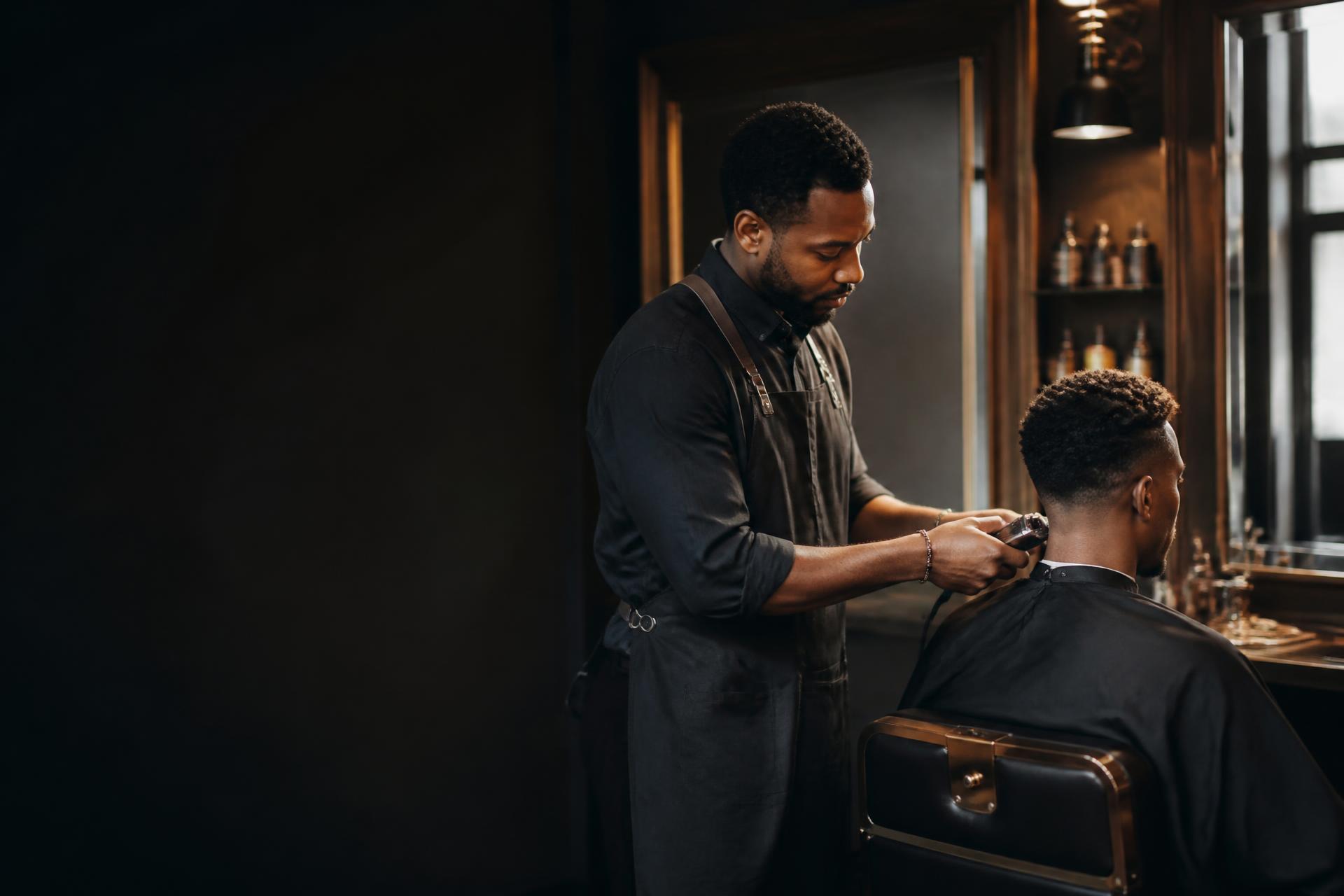 Barber carefully shaping a client's haircut